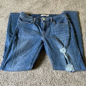 Levi’s 710 Super Skinny distressed jeans with multiple pockets and zip front